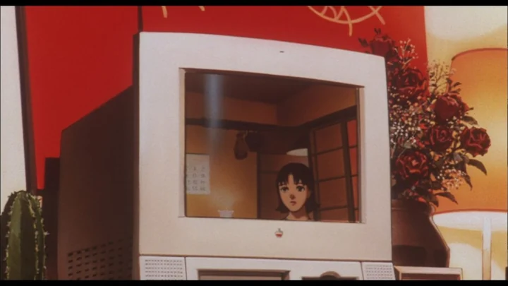 A beige Macintosh showing Mima on its screen, from Perfect Blue